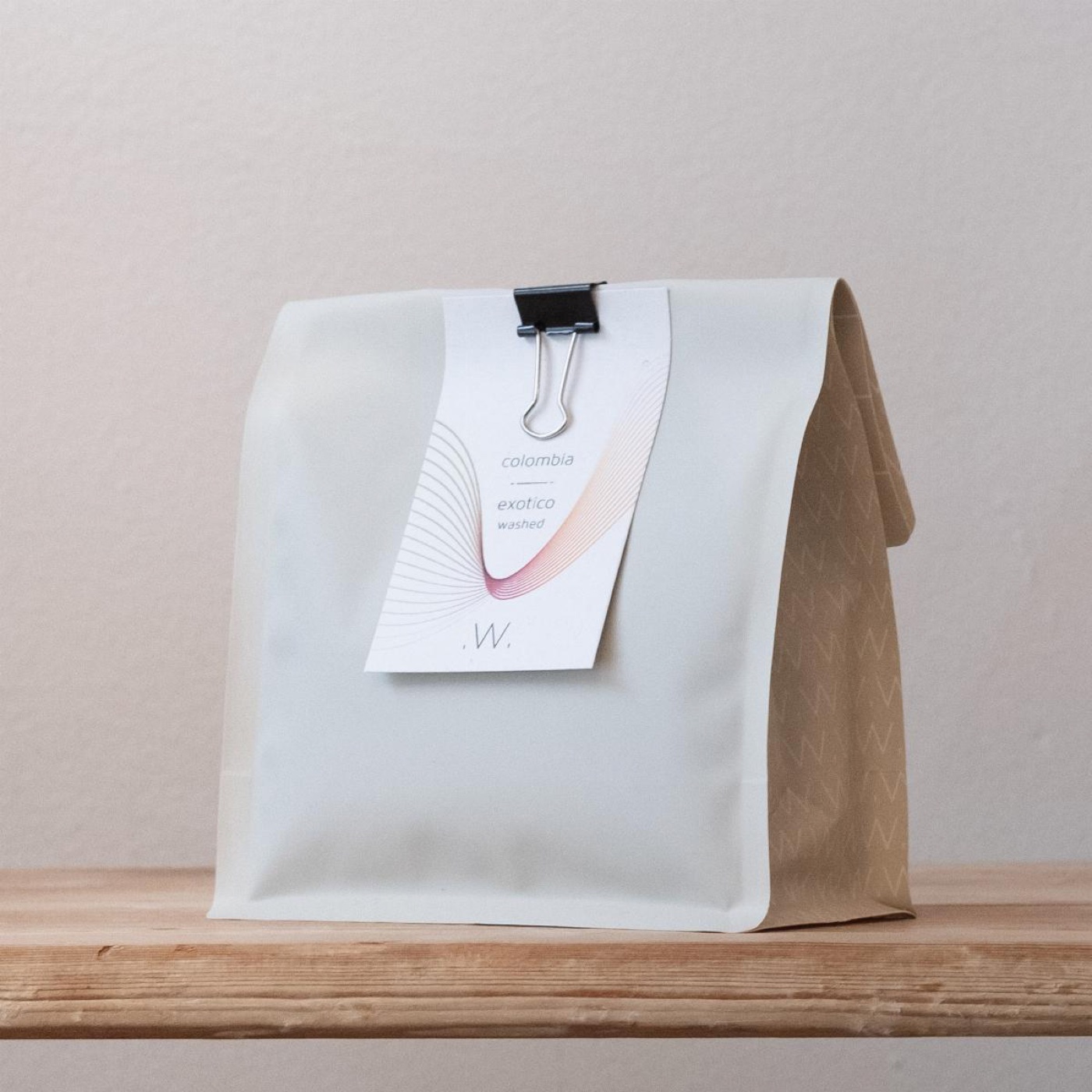A branded White Label Coffee bag, Colombia Exotico washed, standing on a wooden shelf