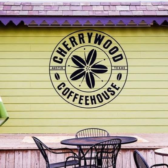 The branded Cherrywood Coffeehouse mural on the exterior wall above the patio