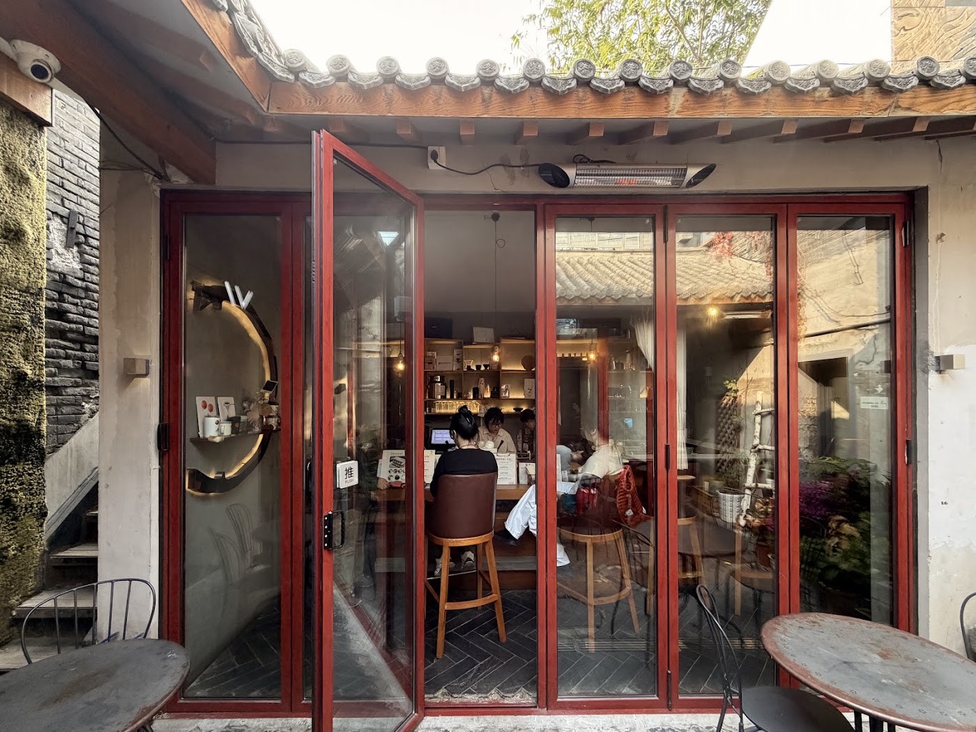 The red framed courtyard entrance to Berrybeans, folding doors open beneath traditional tiled eaves onto the counter inside
