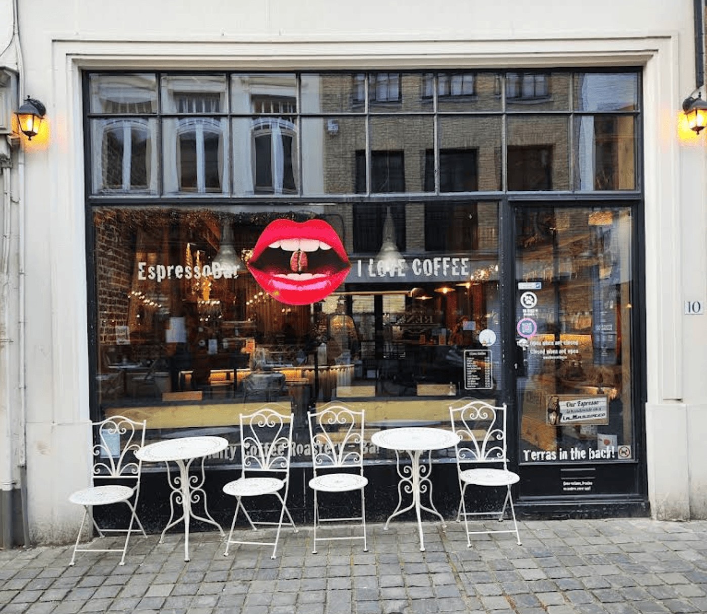 The facade and entrance of I Love Coffee espresso bar on Sint-Jakobsstraat with outdoor bistro seating