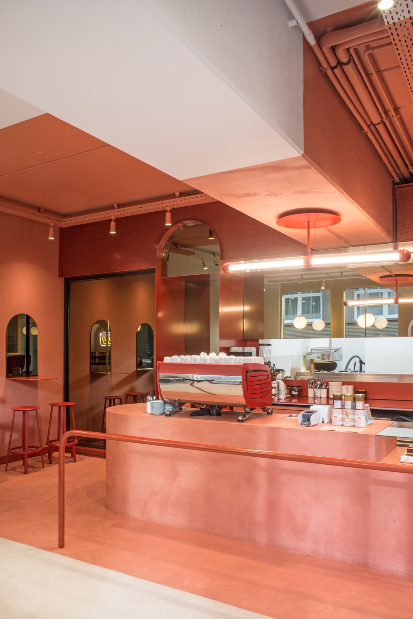 The pink dining room and red La Marzocco espresso machine at Buddy Buddy's Brussels cafe