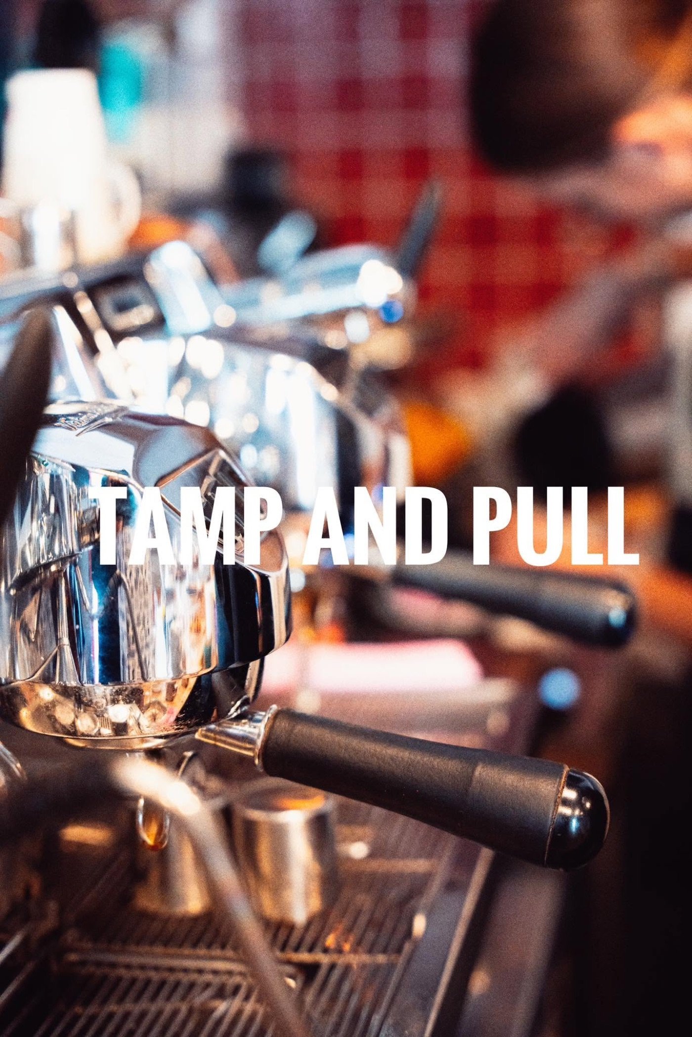 A close view of the espresso machine's group heads and portafilters at Tamp & Pull