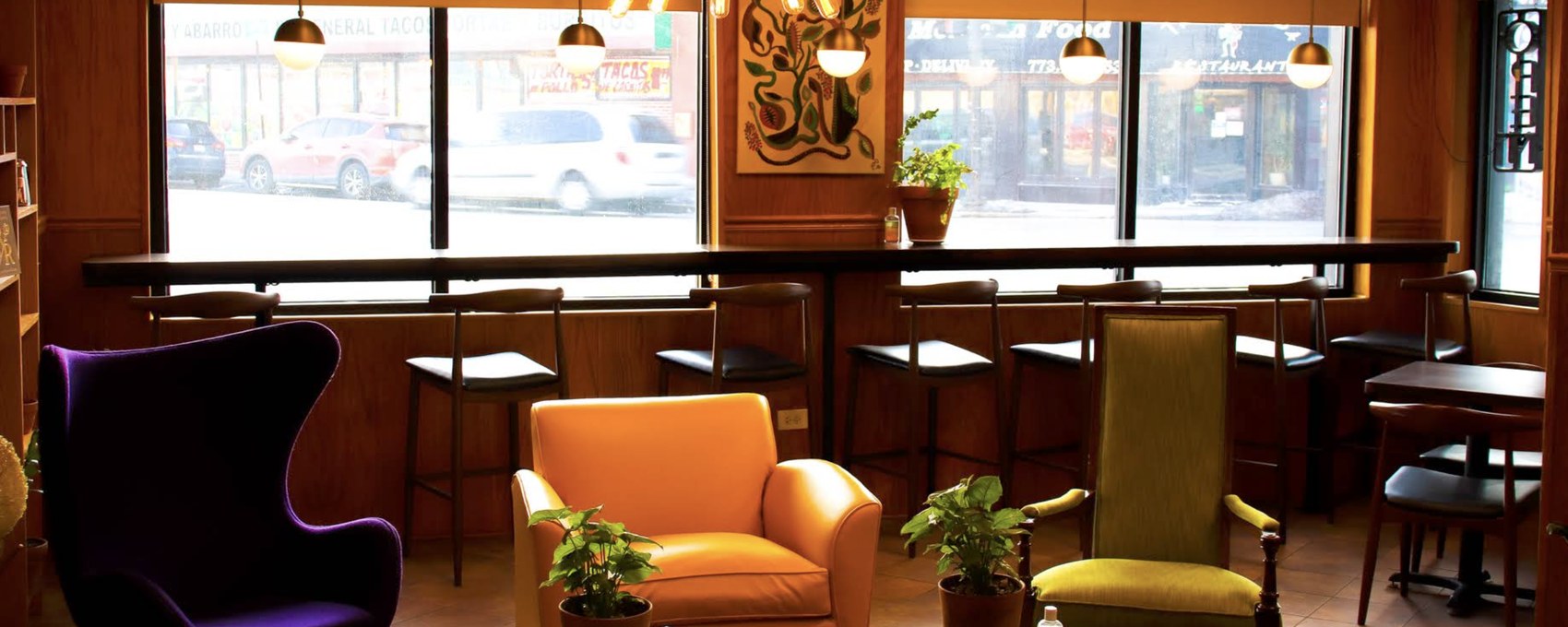 The colorful lounge seating area beside the window bar at The Avondale Coffee Club