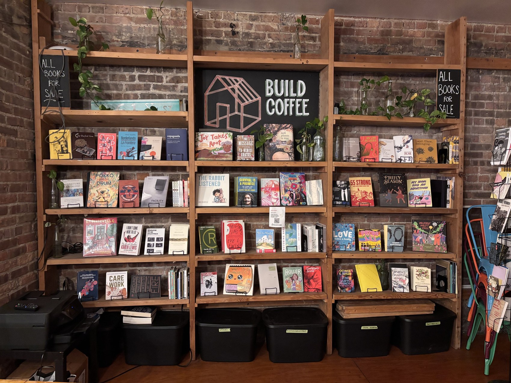 The hand painted Build Coffee sign on the bookshelf stocked with books for sale