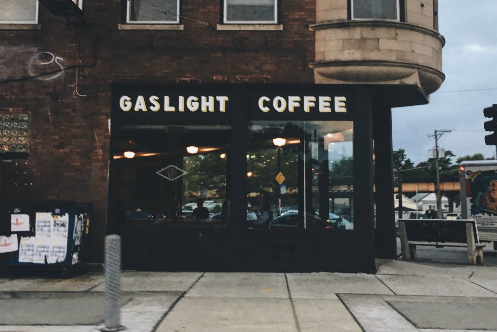 The corner storefront with the painted Gaslight Coffee sign