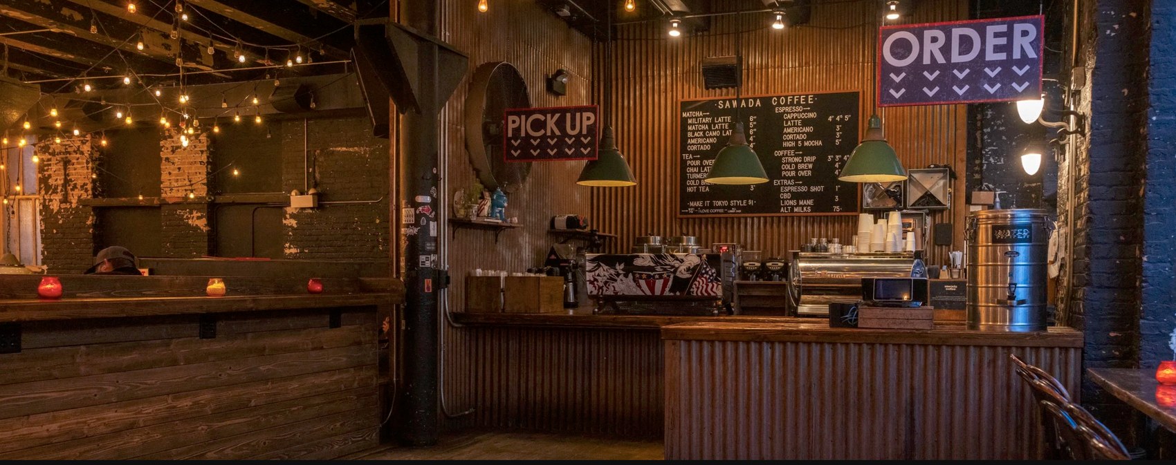 The branded Sawada Coffee menu board beneath string lights