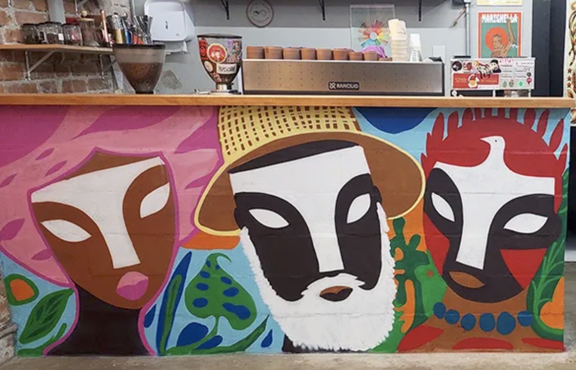 The mural painted counter front and espresso bar at Manifesto Café e Torrefação