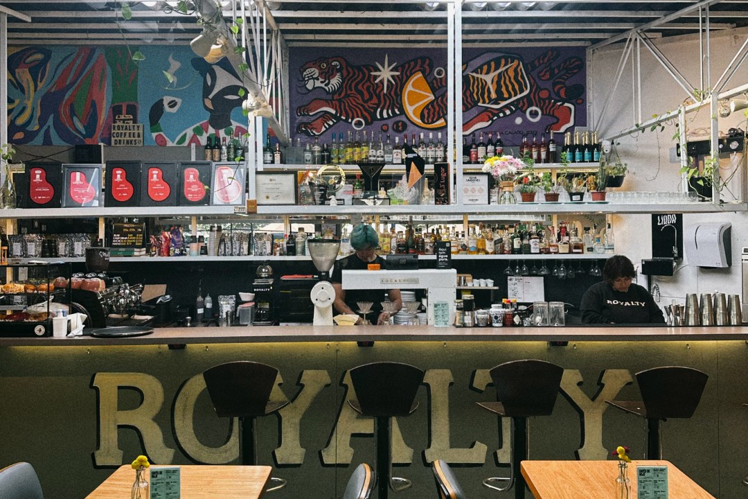 The bar counter and mural backdrop at Royalty Café