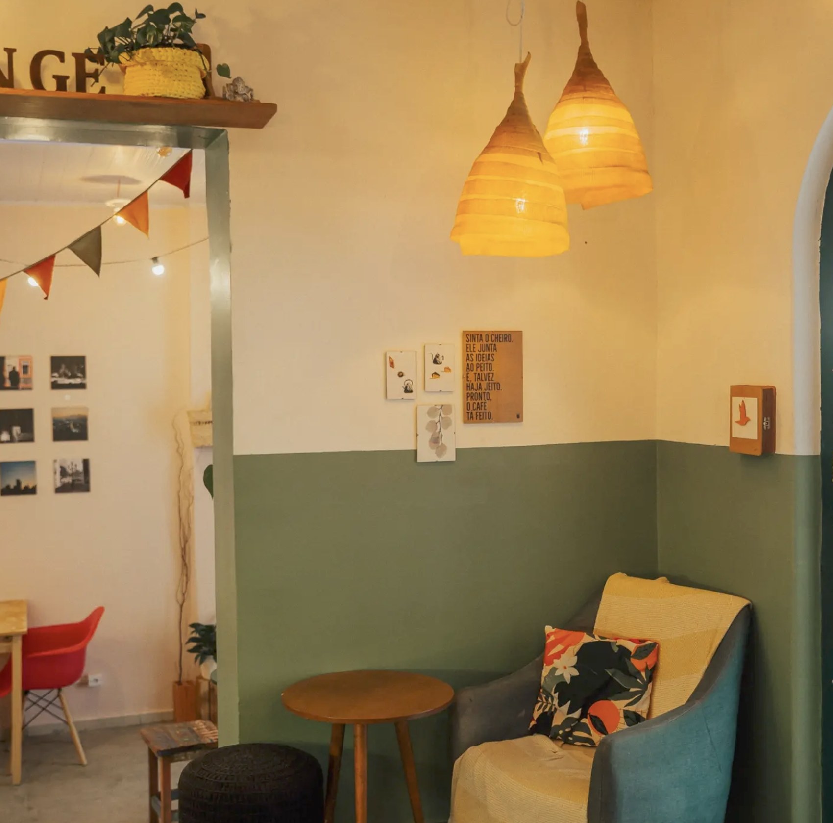 A lounge corner with pendant lamps and framed photography at Tangerina Café