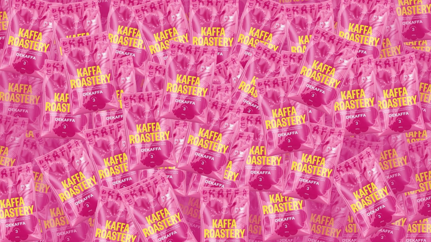 A wall of pink Kaffa Roastery Dekaffa retail coffee bags stacked edge to edge