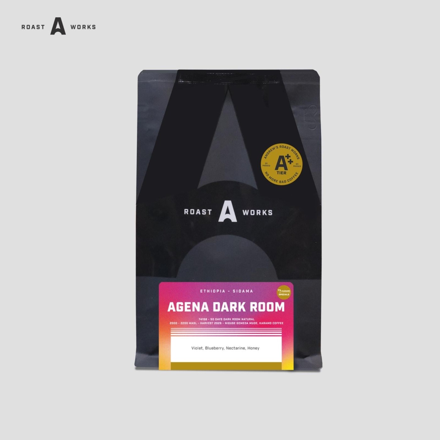 A black Roast A Works coffee bag labeled Agena Dark Room, Ethiopia Sidama, standing upright against a plain grey background