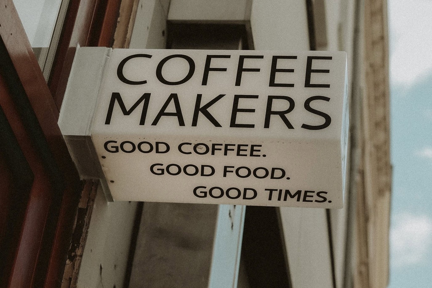 The Coffee Makers sign mounted above the storefront entrance, reading Good Coffee, Good Food, Good Times