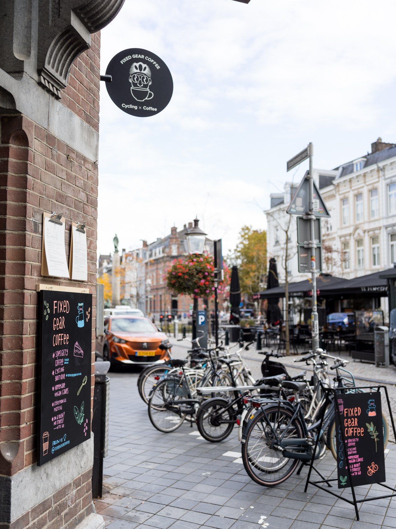 The Fixed Gear Coffee storefront sign and hand lettered chalkboard menu with bicycles parked out front