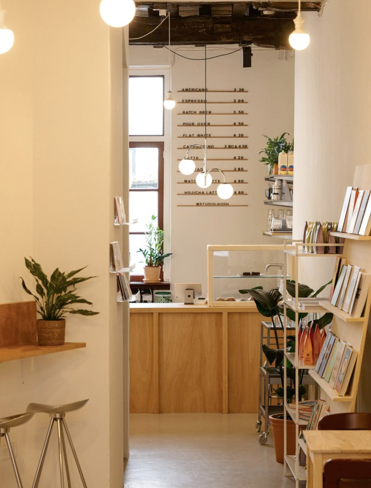 The counter and menu board inside Studio Nosh, with design shop shelving alongside