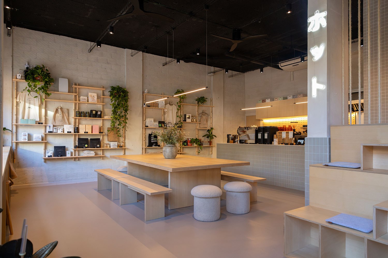 The retail shelving, communal wood table and espresso counter at Surry Hills Coffee