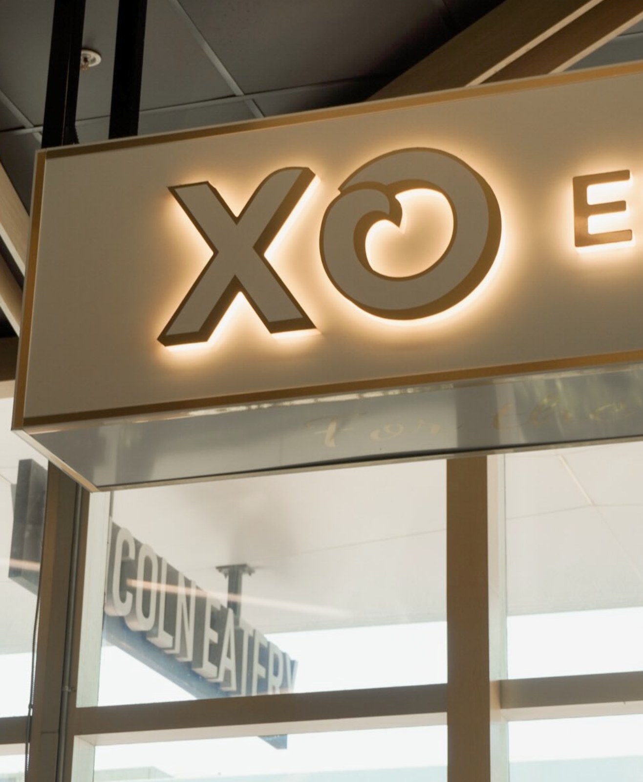 The illuminated XO sign above the Lincoln Eatery entrance