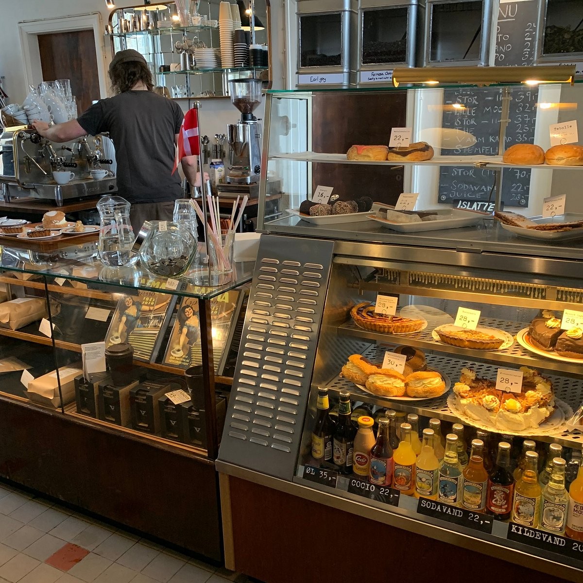 The vintage counter and pastry case at Velodrom Kaffebar inside the former Fruens Bøge station building