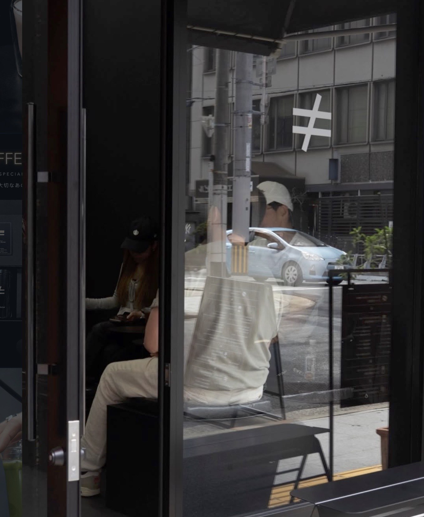 The Notequal Coffee storefront with the not equal sign logo reflected in the glass door and customers seated at an outdoor table