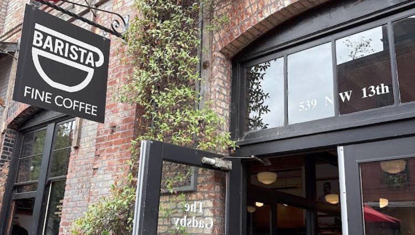 The BARISTA FINE COFFEE sign hanging above the brick storefront entrance at 539 NW 13th