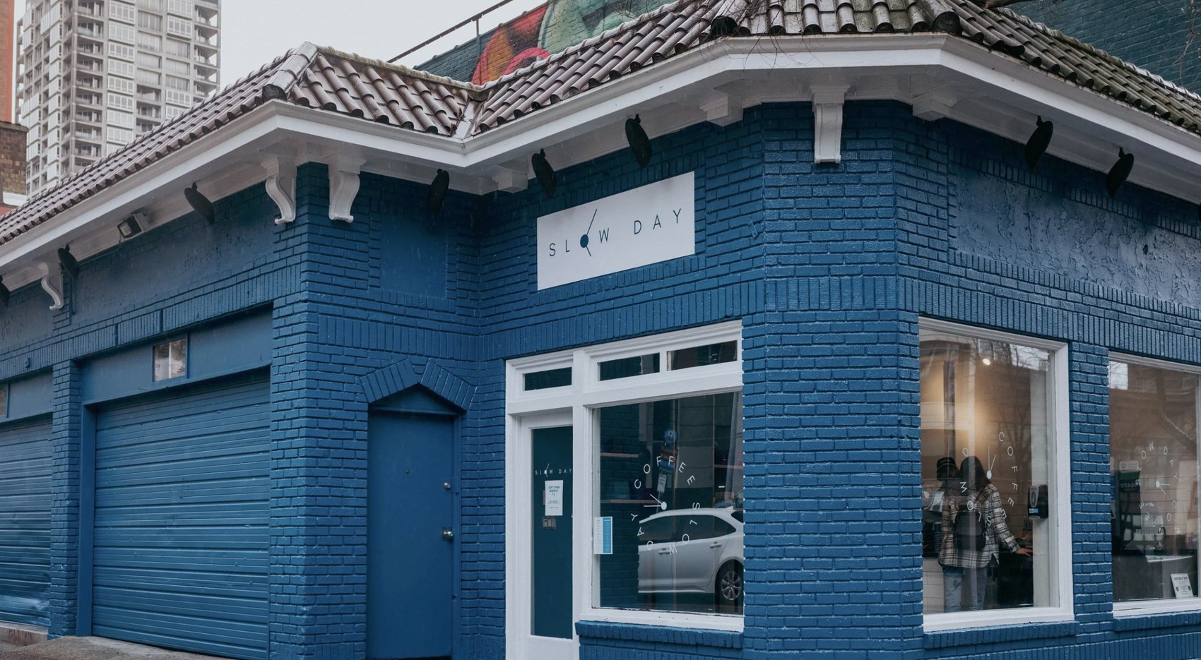 The blue brick corner building with the Slow Day sign