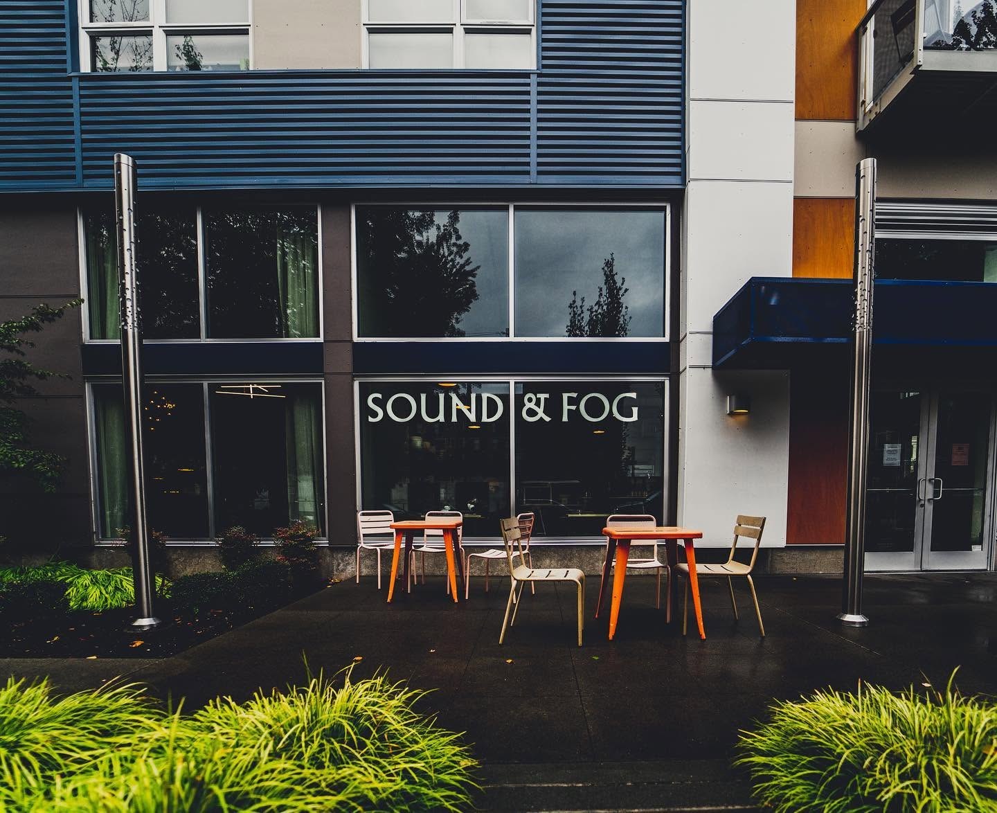The Sound & Fog storefront window with the outdoor patio tables and chairs in front