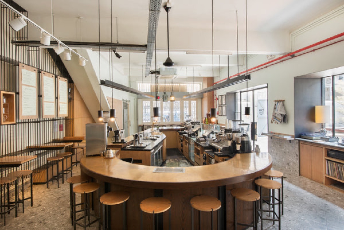 The curved wooden counter and open coffee bar inside Chye Seng Huat Hardware's conserved Art Deco shophouse