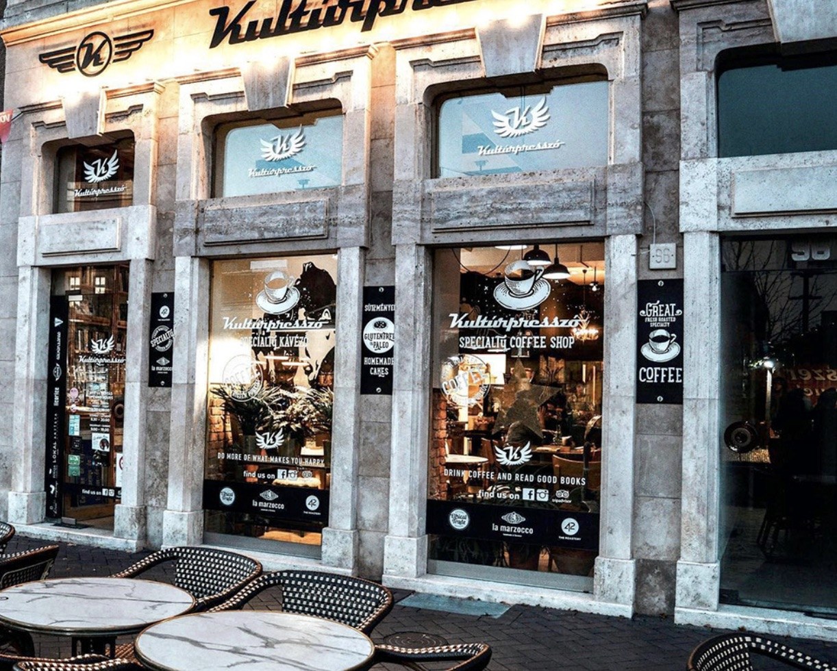The Kultúrpresszó storefront on Várkerület, with specialty coffee shop signage etched on the windows