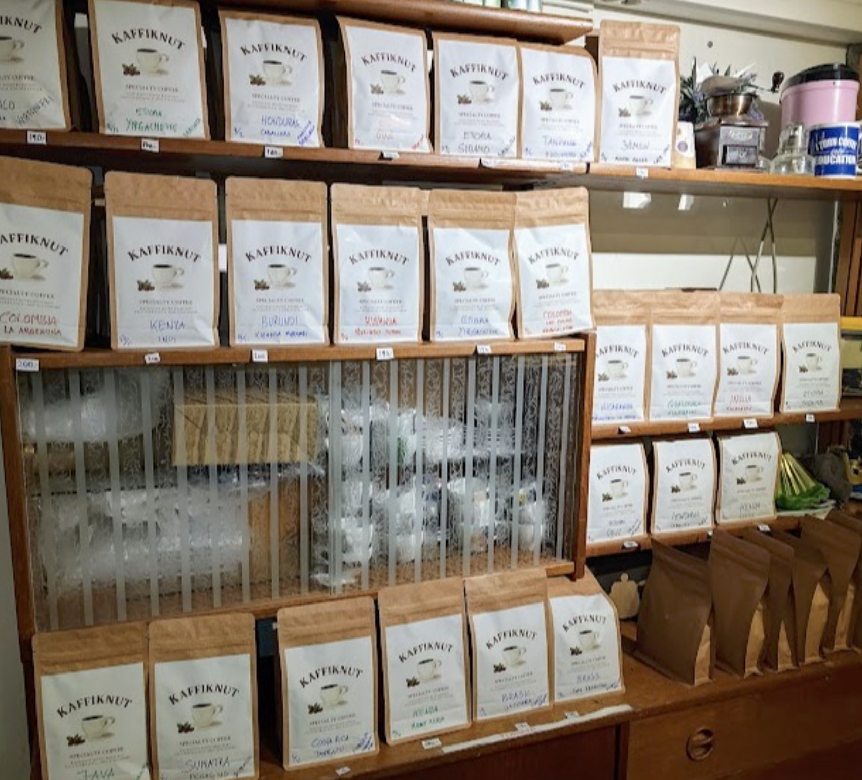 Shelves of hand labeled Kaffiknut origin bags at the shop
